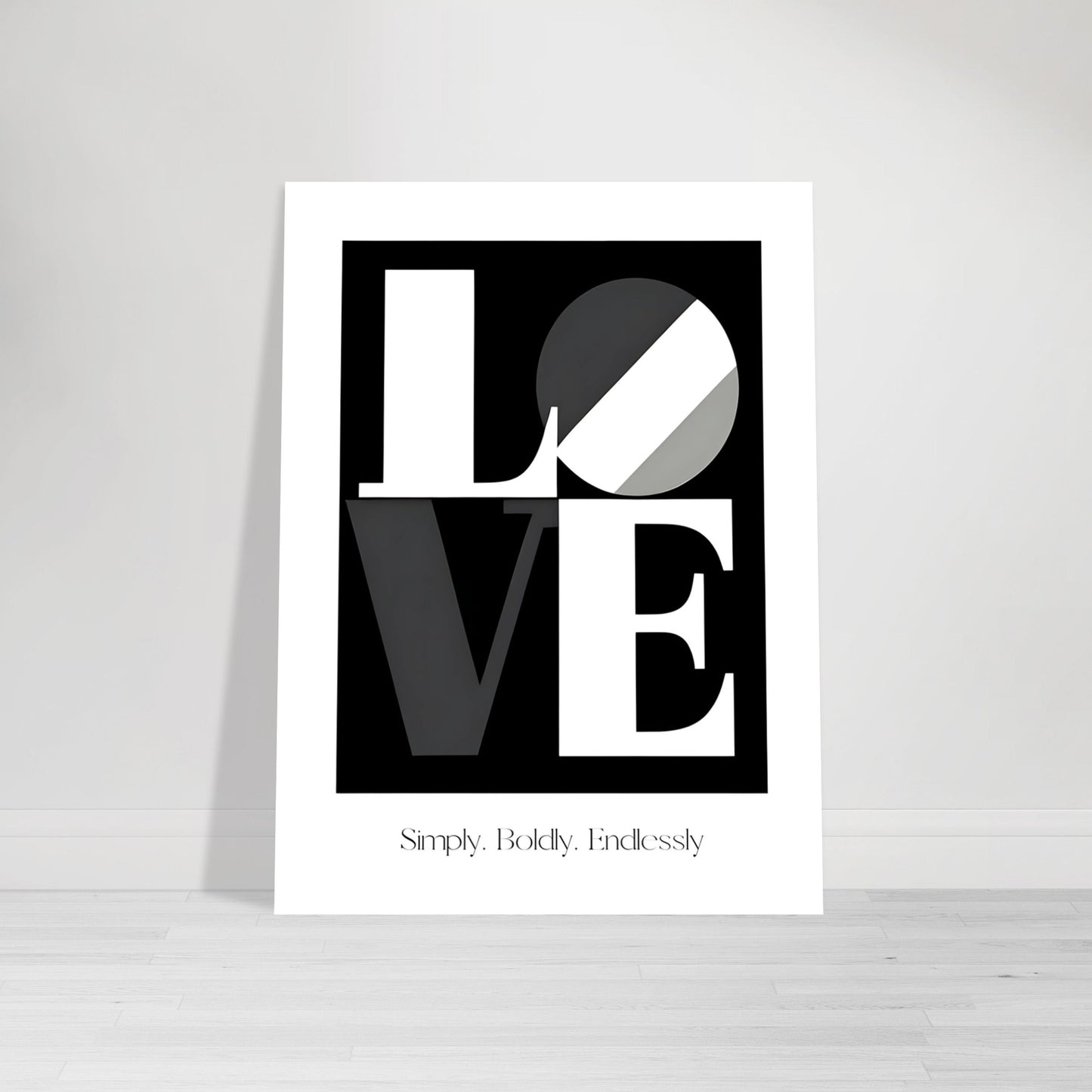 Unframed black and white LOVE typography poster with modern design, styled upright on a light wooden floor against a white wall