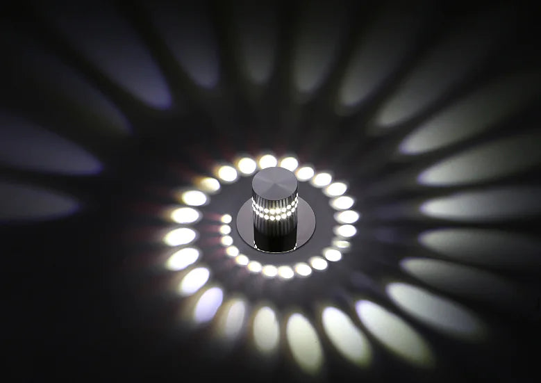 Close-up of a ceiling light fixture with circular design and illuminated pattern.