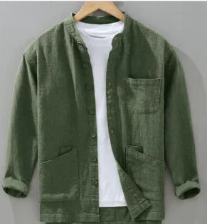 Green jacket on a hanger against a gray background