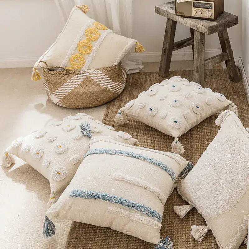 Collection of bohemian-style cushion covers in various Moroccan-inspired patterns, displayed on a modern sofa with neutral decor tones.