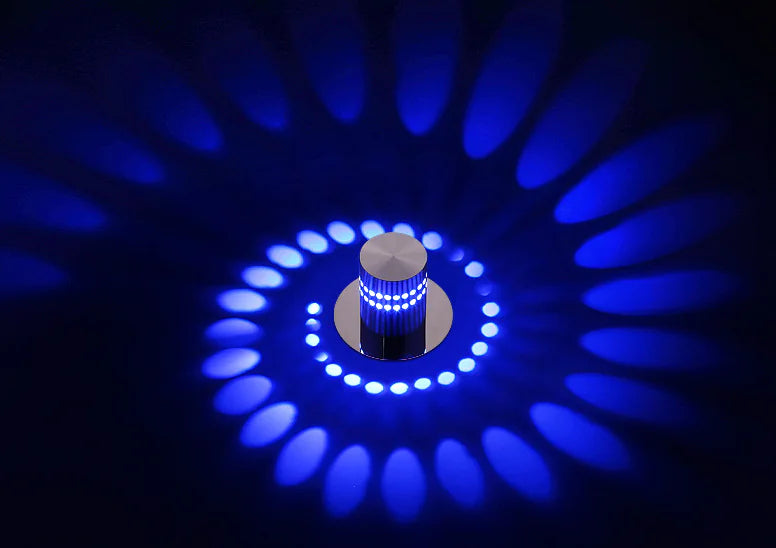 Circular light pattern with a central cylindrical object on a dark background