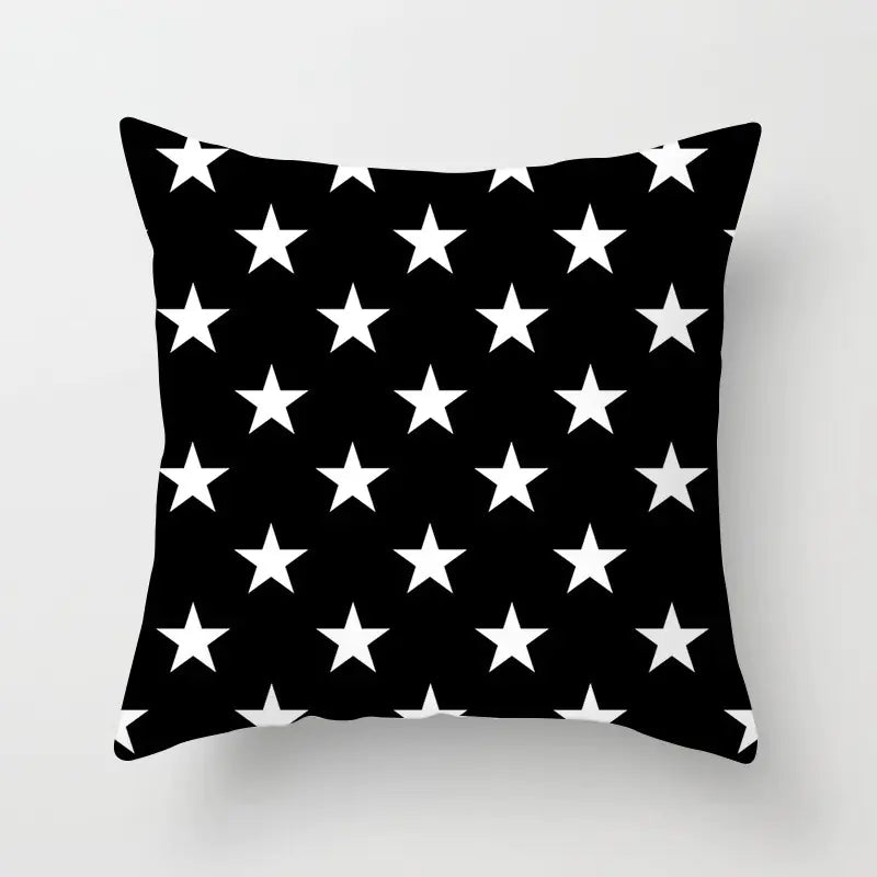 Black pillow with white star pattern on a light gray background