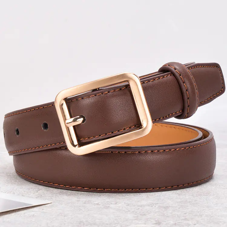 Brown leather belt with a gold buckle on a light gray background