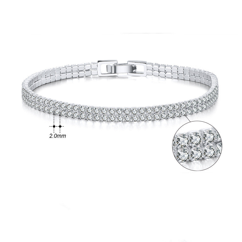 Silver bracelet with clear stones on a white background