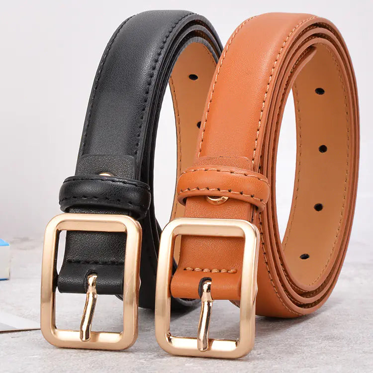Two leather belts with gold buckles, one black and one brown, on a light gray background.