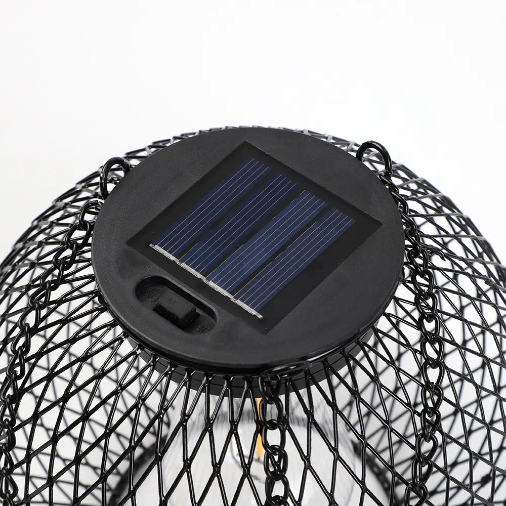 Solar-powered outdoor light fixture with black metal cage on a white background