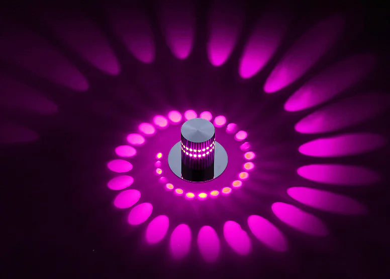 Circular light fixture with pink LED lights on a dark background