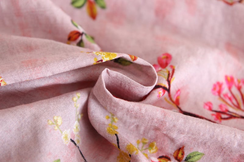 Close-up of floral fabric with pink background