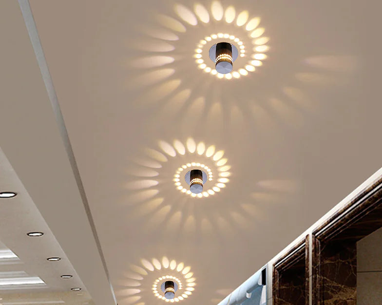 Ceiling with recessed lighting fixtures casting circular shadows on a neutral ceiling.