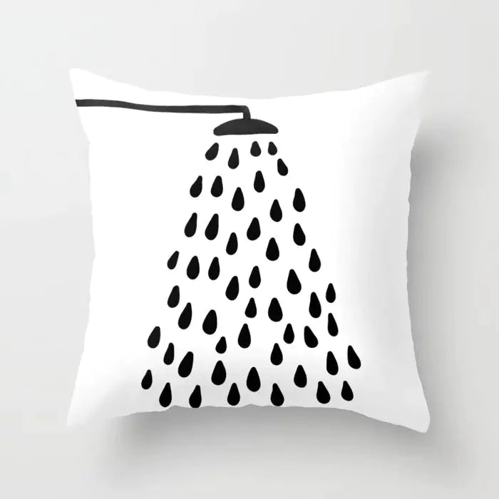 White pillow with black shower head and water droplets design on a white background
