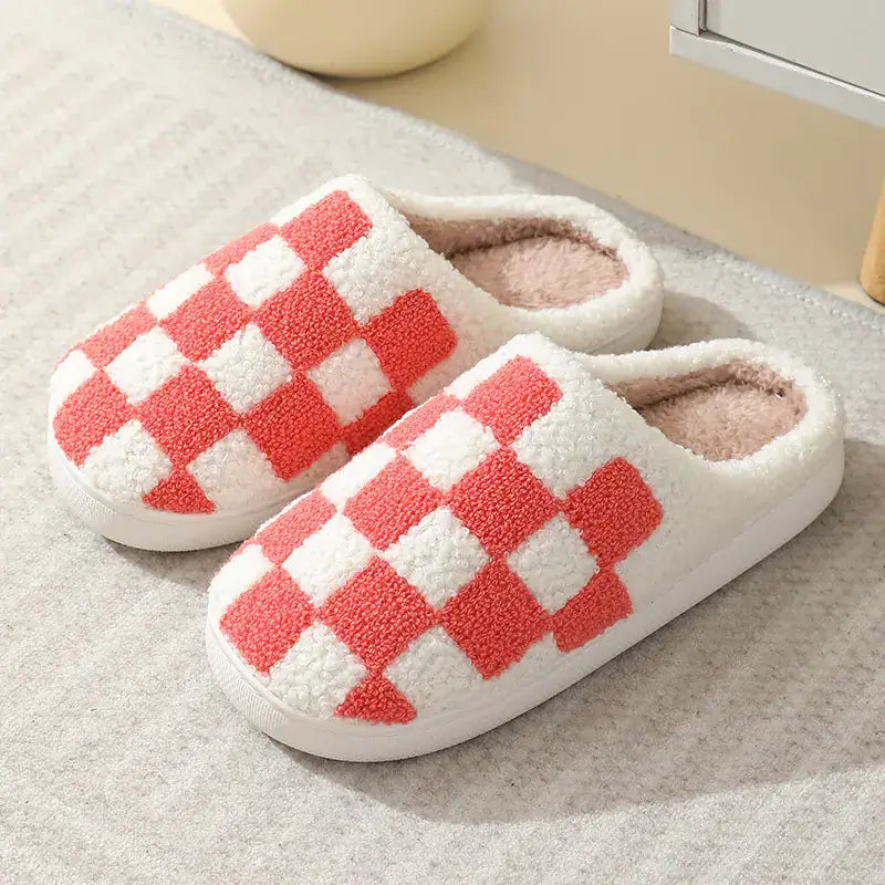 Pair of checkered slippers on a textured surface
