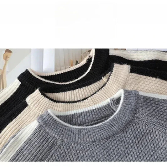 Three sweaters in black, beige, and gray on a white background