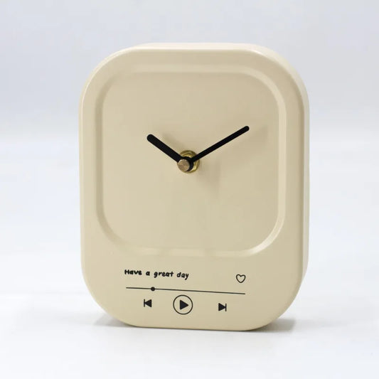 Beige clock with black hands and text on a white background