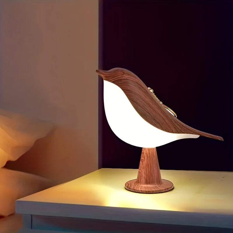 Wooden bird-shaped lamp on a table with a dark background