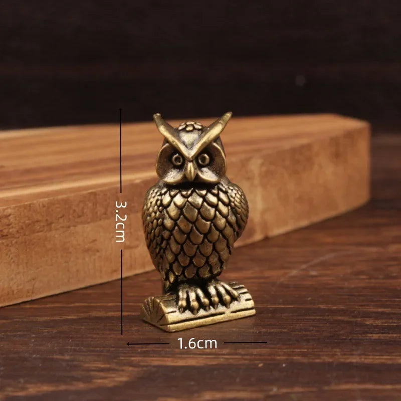 Small brass animal ornament figurine with detailed finish placed on a desk as decorative accent