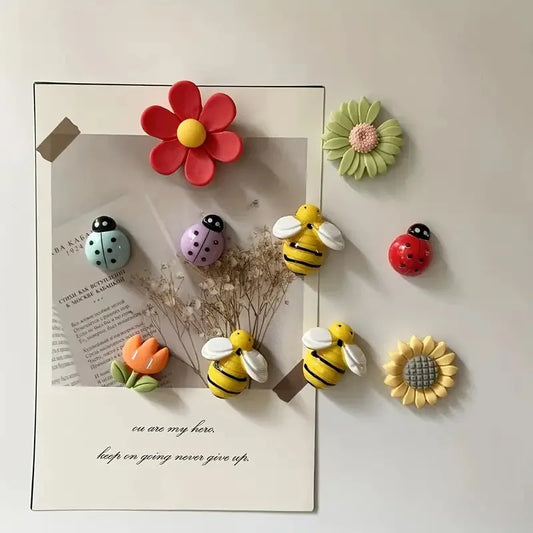 Cute bee and flower fridge magnets set with pastel floral and ladybird designs displayed on minimalist refrigerator surface