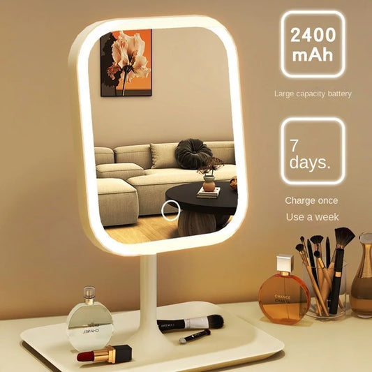 Lighted makeup mirror with cosmetic items on a table, battery capacity information displayed.