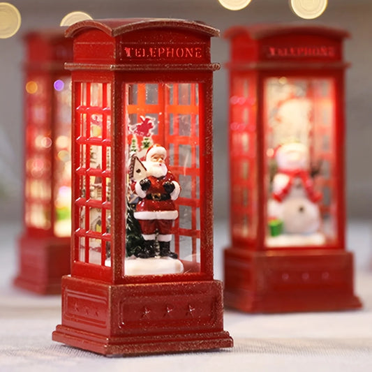 Decorative red telephone booth with Santa Claus and a snowman inside, on a blurred background.