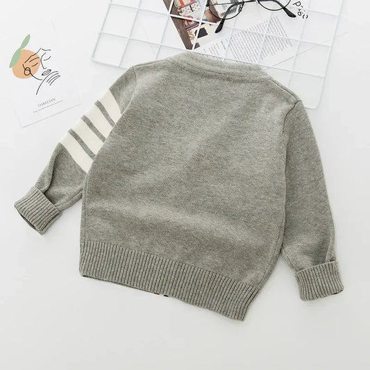 Gray sweater with white stripes on sleeves on a light background