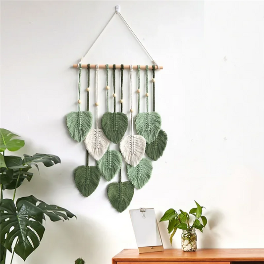 Decorative wall hanging with leaf patterns on a white wall.