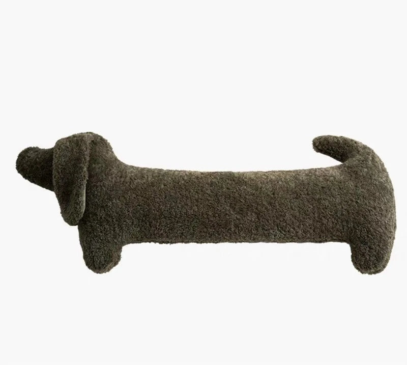Green dog-shaped cushion on a white background