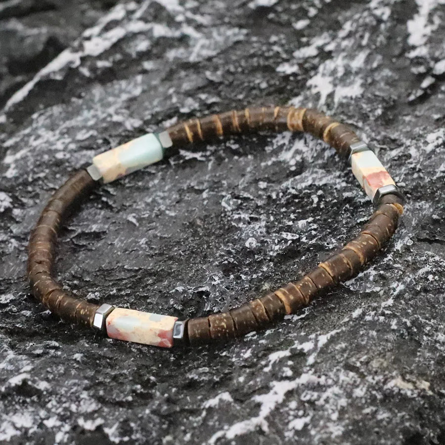 Necklace with brown and white beads on a textured surface