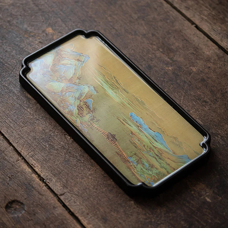 Bamboo Serving Tray with artistic design on a wooden surface