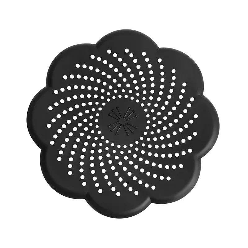 Black silicone strainer with floral design on a white background