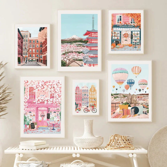 Set of framed artworks on a wall with a decorative table below.