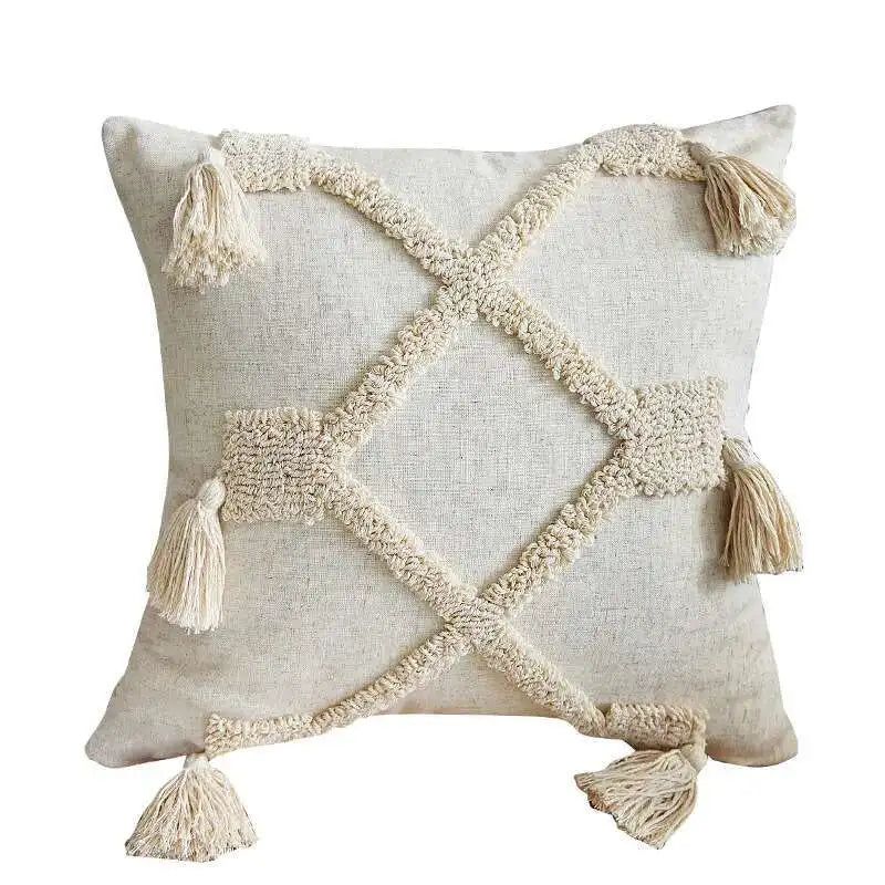 Decorative pillow with geometric pattern and tassels on a white background