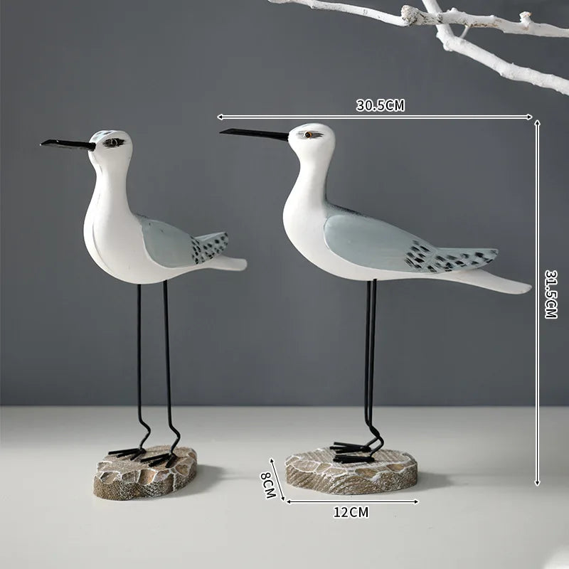 Two decorative bird figures with measurements on a gray background