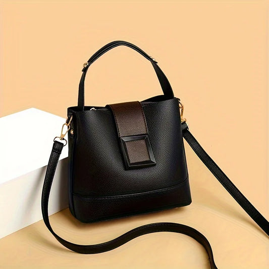 Black handbag with a strap on a beige background