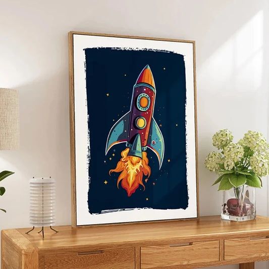 Framed artwork of a rocket ship on a wall above a wooden cabinet.