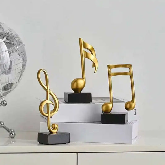 Set of three modern resin musical note sculptures with black bases displayed as contemporary home décor, available in black, white and gold finishes.