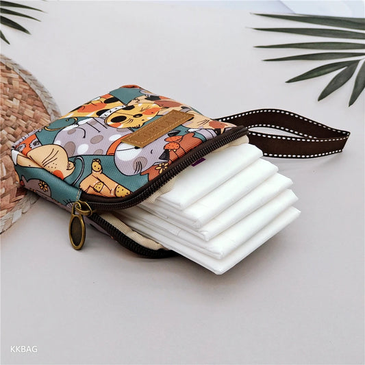 Colorful cartoon-patterned pouch with a stack of white items on a light surface.