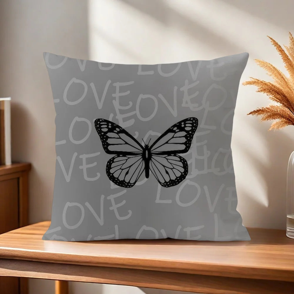 Gray pillow with a butterfly design on a wooden surface