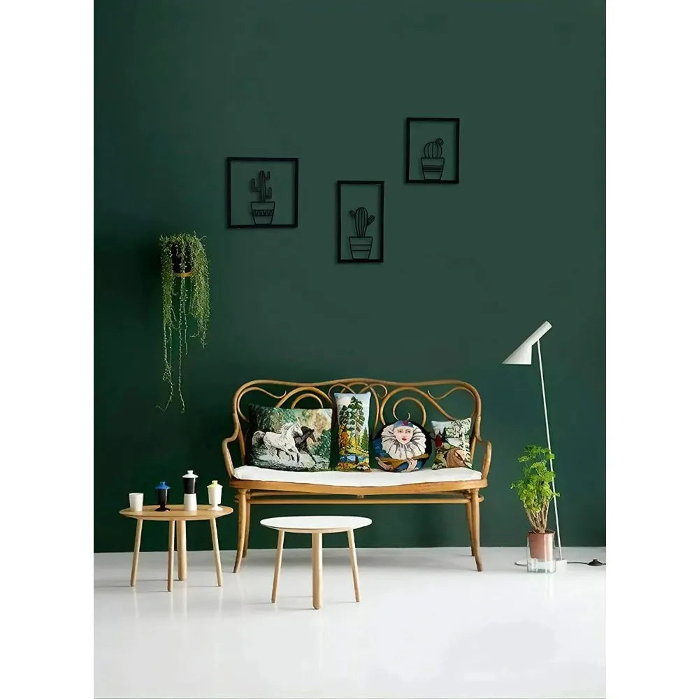 Living room with a wooden sofa, decorative pillows, and a green wall and a Three piece black metal cactus wall art set displayed on a green wall