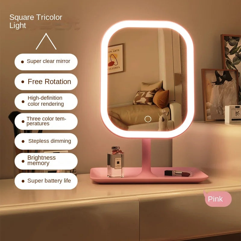 Square tricolor light mirror with pink base on a shelf, surrounded by decor items.