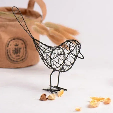 Black wire bird sculpture with a blurred background