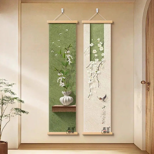 Two vertical wall scrolls with floral designs hanging on a beige wall.