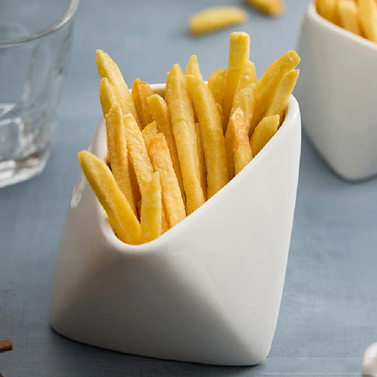 White ceramic container filled with French fries on a gray surface.