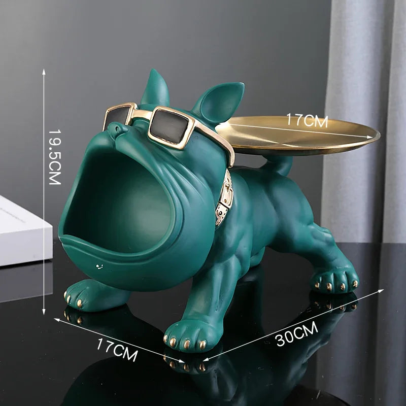 Green dog-shaped object with sunglasses and a tray, shown with measurements on a dark surface.