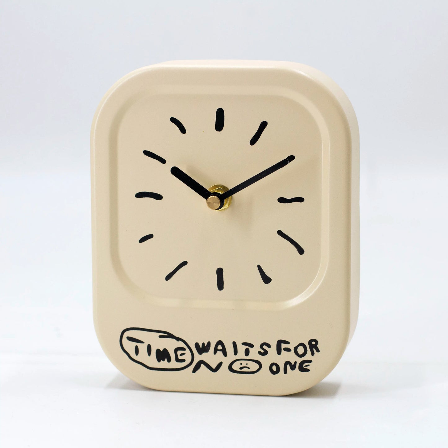 Beige clock with black hands and 'Time Waits For No One' text on a white background
