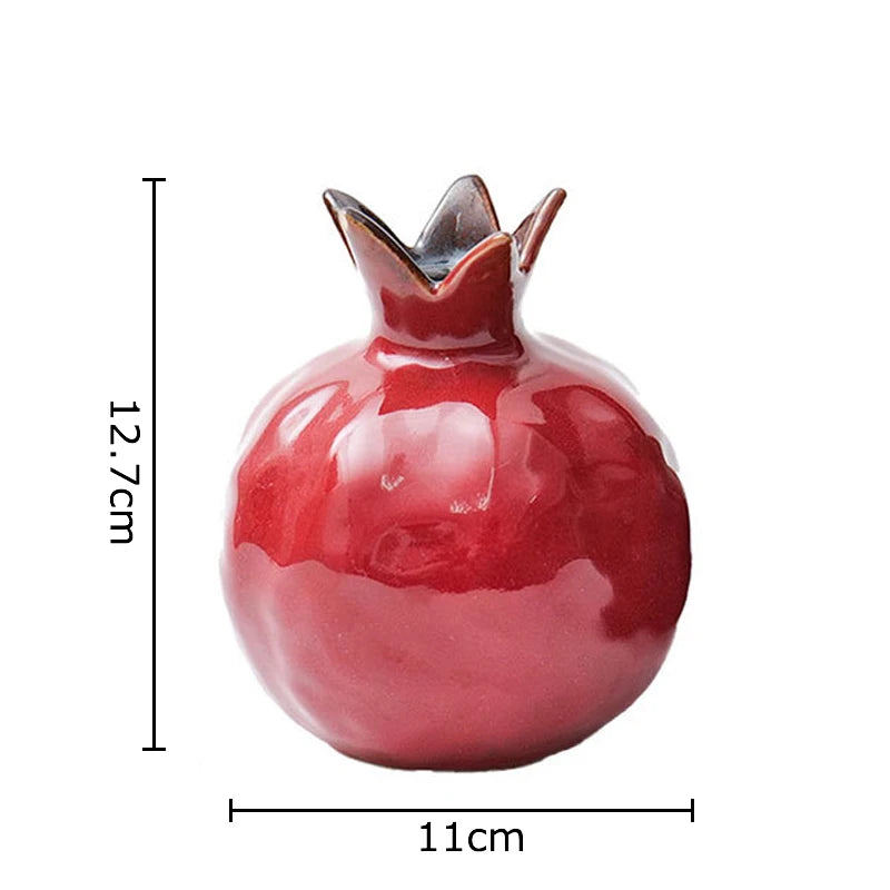 Red ceramic pomegranate-shaped object with measurements on a white background