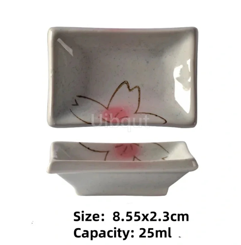 Two small ceramic dishes with floral designs on a white background
