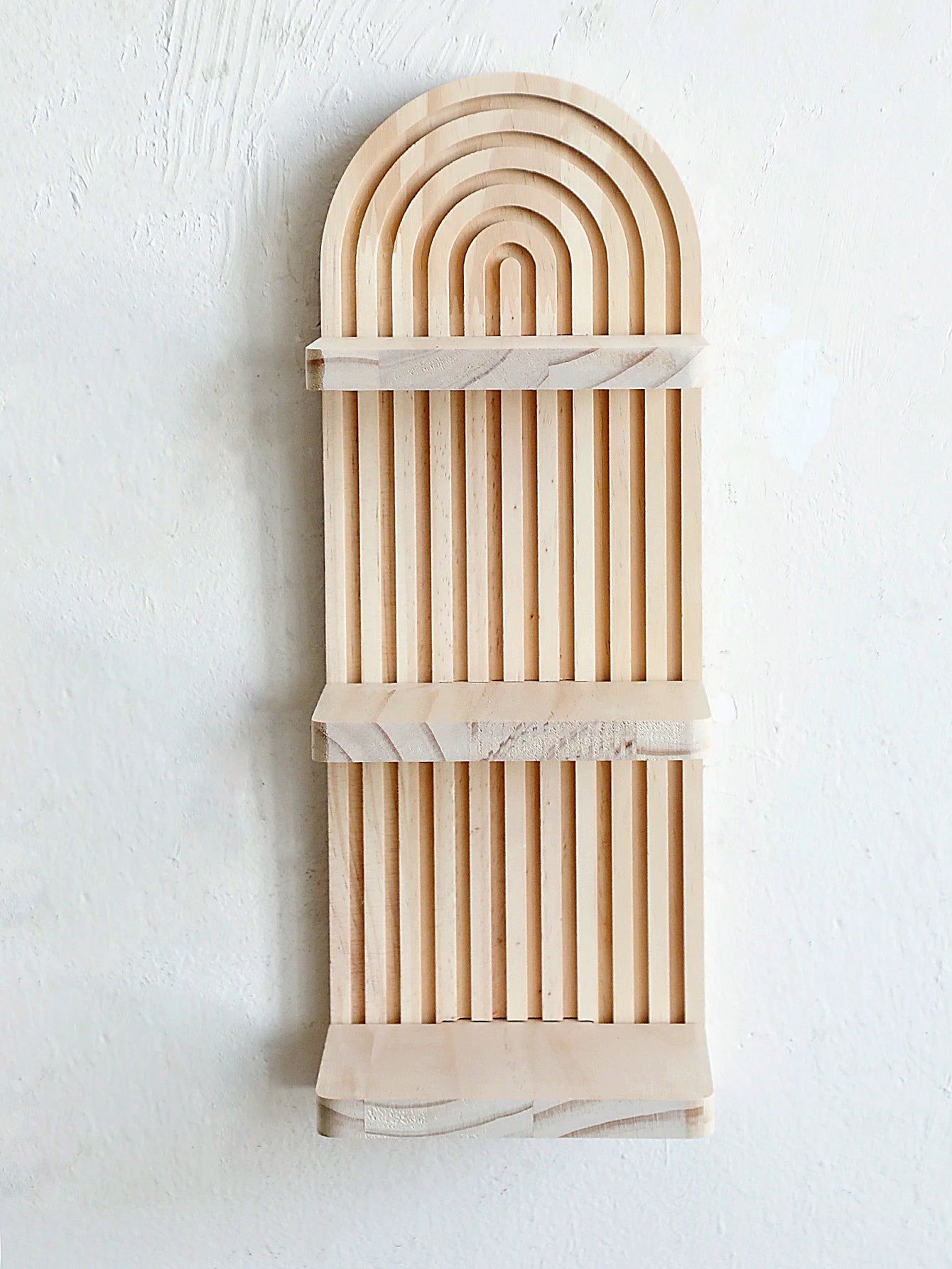 Decorative wall piece with arch design and marble accents on a white background