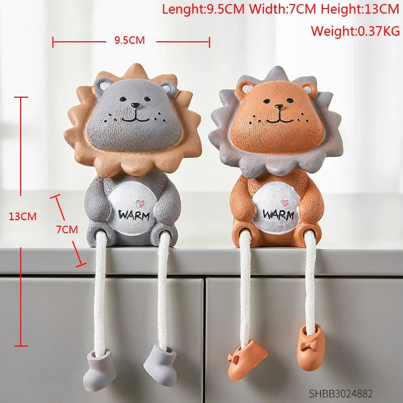 Two lion-shaped baby teether toys with measurements on a white background