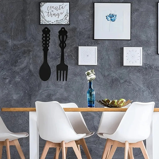 Dining area with a table, chairs, and decorative elements on a gray wall.