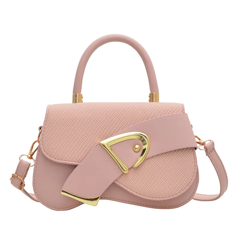 Pink handbag with gold accents on a white background