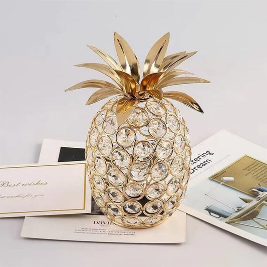 Decorative pineapple with crystal details on a surface with papers underneath